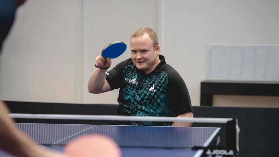 Player laughing as he serves
