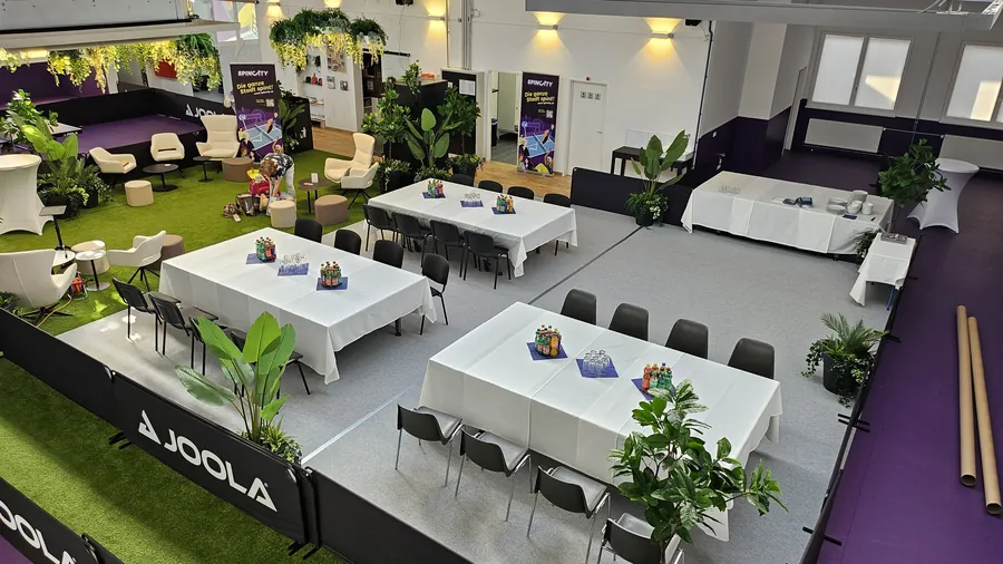 Seminar tables with white tablecloths set up in the hall