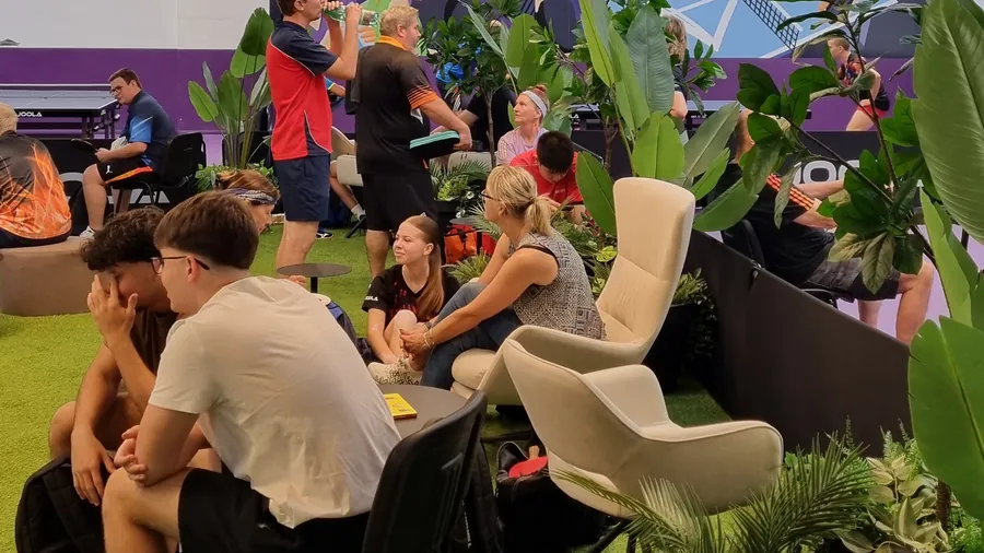 Busy lounge with guests among the plants