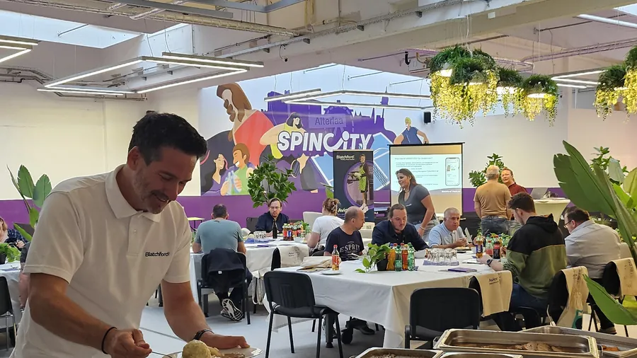 Guests at laid tables, someone serving himself at the buffet in front