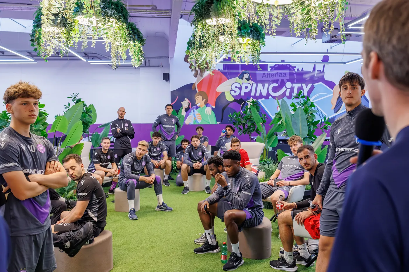 Team seated in the SpinCity lounge listening to a talk